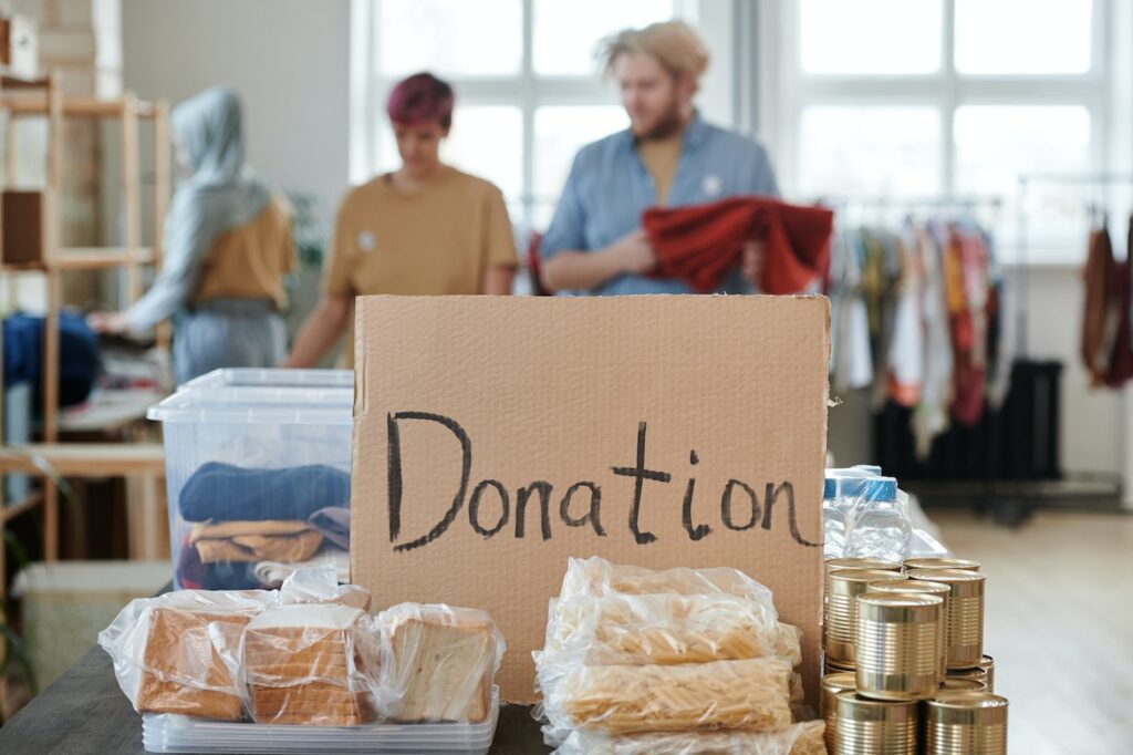 A table of charitable donations with students in the background
